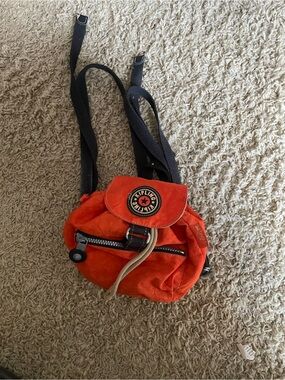 Kipling Bright Orange Mini Backpack with Black Straps.Small